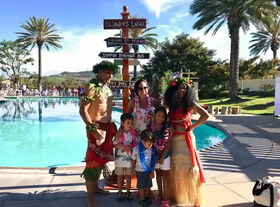 A Family Welcome Beside the Poolside Island Sign