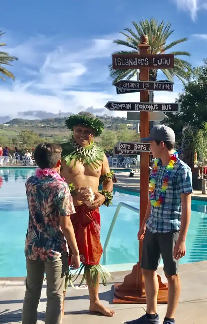 Guests Chatting with a Luau Greeter by the Pool